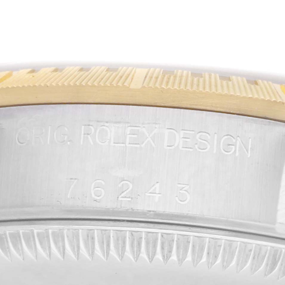 The image shows a close-up of the case side of the Rolex Oyster Perpetual men's watch, model number 76243, highlighting the engraving and bezel edge.