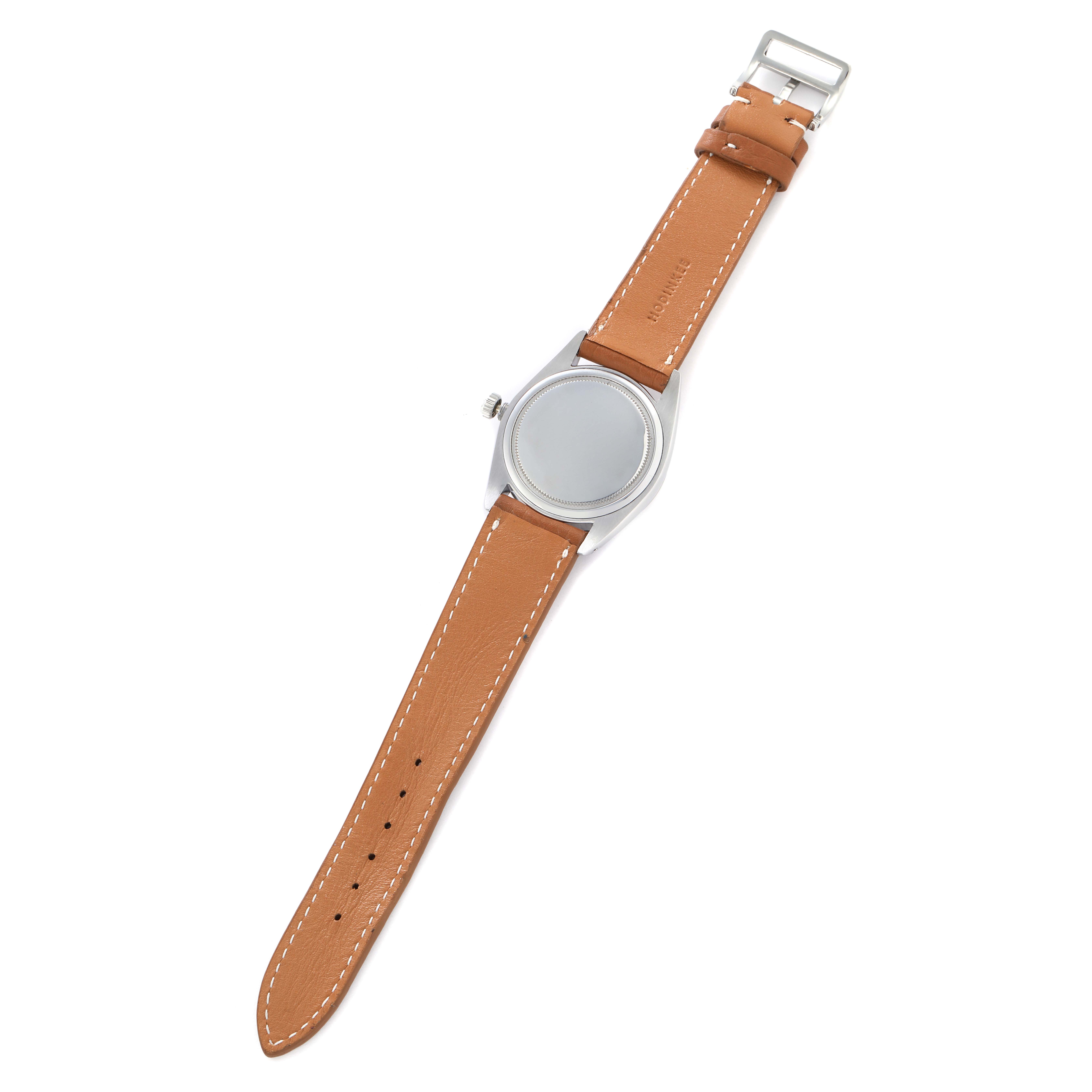 The image shows the back view of a Rolex Vintage Collection model 6694 men
s watch with a tan leather strap.