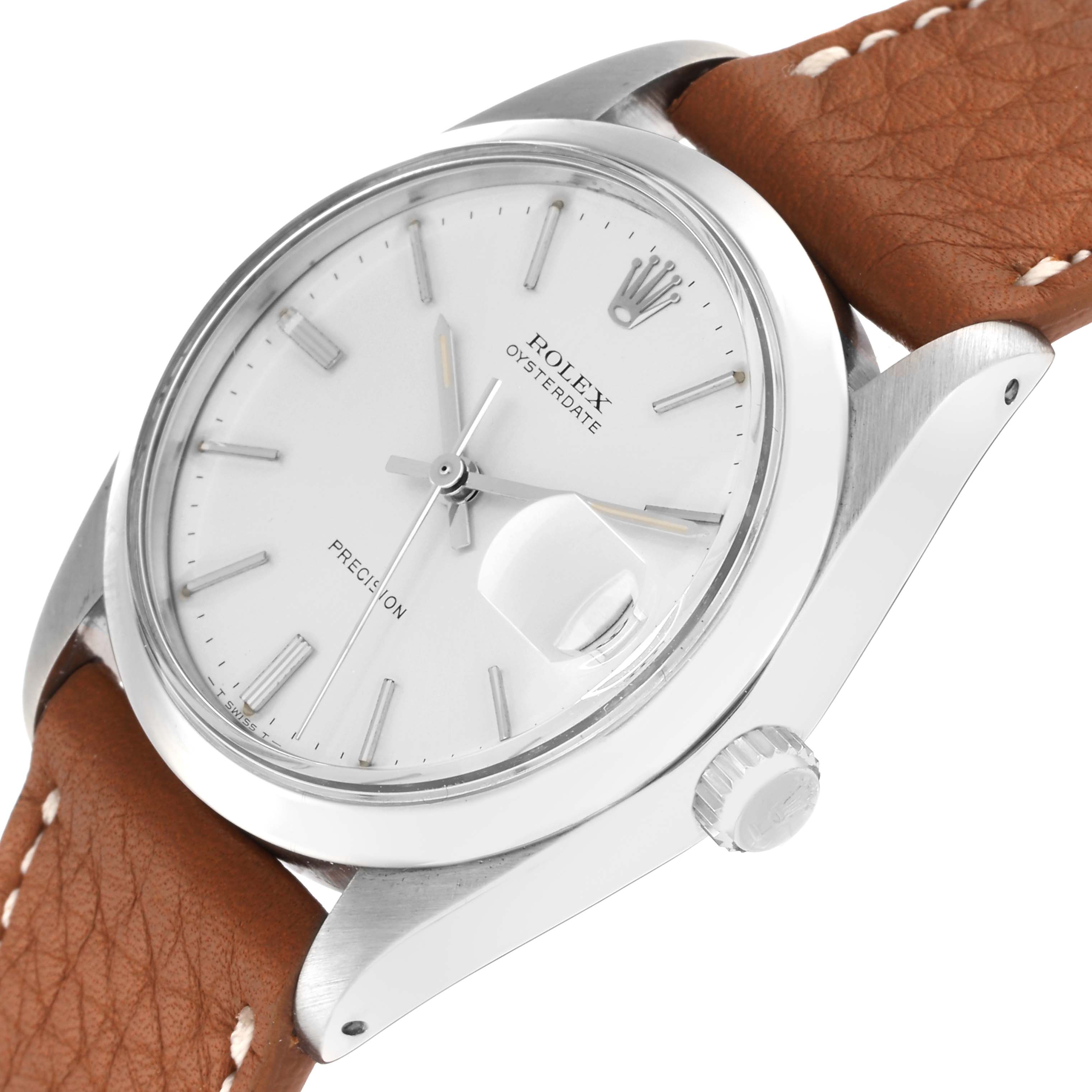 The Rolex Vintage Collection model 6694 is shown at an angled close-up, highlighting the dial, crown, and partial brown leather strap.