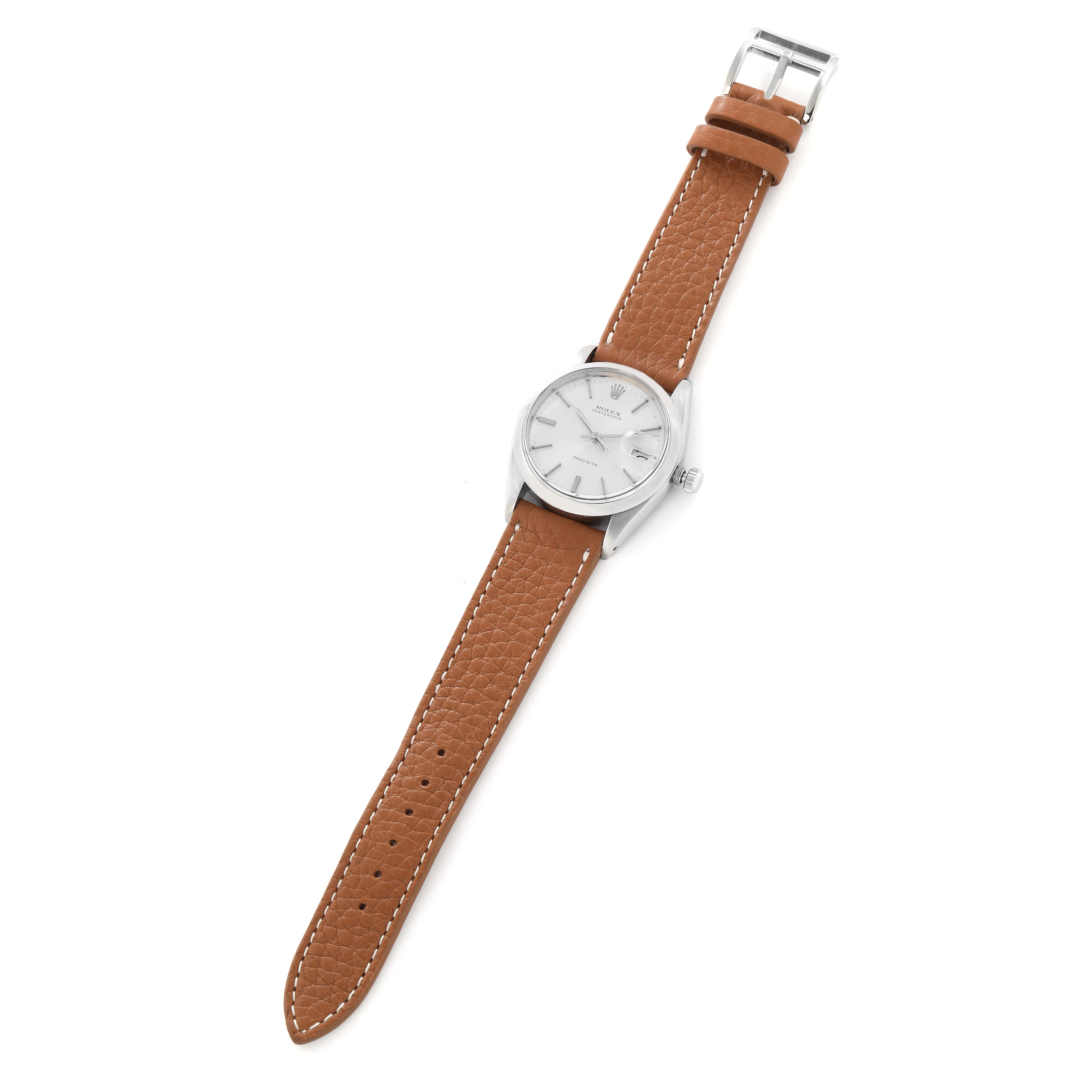 The Rolex Vintage Collection model 6694 men
s watch is shown from a slightly angled top view, displaying the silver dial, case, and leather strap.