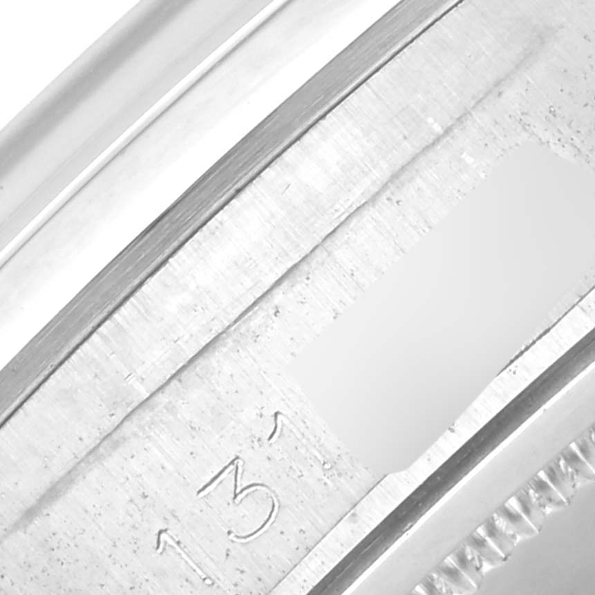 This image shows a close-up of the case back and part of the case edge of a Rolex Vintage Collection 6694 Men's Stainless Steel Silver Dial 6694 Men's Stainless Steel Silver Dial watch.