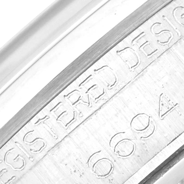 This close-up image shows the serial number engraving on the case of a Rolex Vintage Collection 6694 Men's Stainless Steel Silver Dial 6694 Men's Stainless Steel Silver Dial model watch.