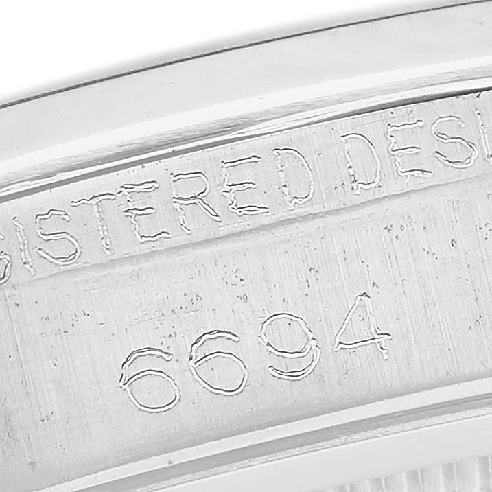 This close-up image shows the engraved model number "6694" on the case of a Rolex Vintage Collection 6694 Men's Stainless Steel Silver Dial 6694 Men's Stainless Steel Silver Dial watch.