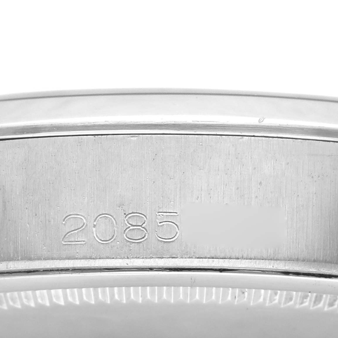 This image shows the edge of the case back of a Vintage Collection Rolex watch with engraved numbers.