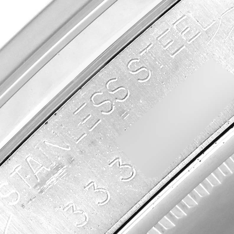 This close-up image shows the side of the bezel and a part of the casing with the engraving of a Rolex Vintage Collection 6694 Men's Stainless Steel Silver Dial 6694 Men's Stainless Steel Silver Dial watch.