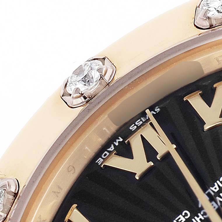 The image shows a close-up of the bezel with diamonds and part of the dial of a Rolex Pearlmaster 81318 Women's Yellow Gold Black Dial watch.