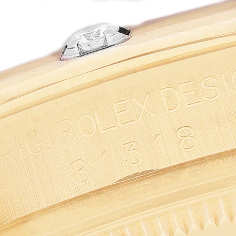 The image shows a close-up of the Rolex Pearlmaster 81318 Women's Yellow Gold Black Dial's side, highlighting engraved details and a diamond on the bezel.