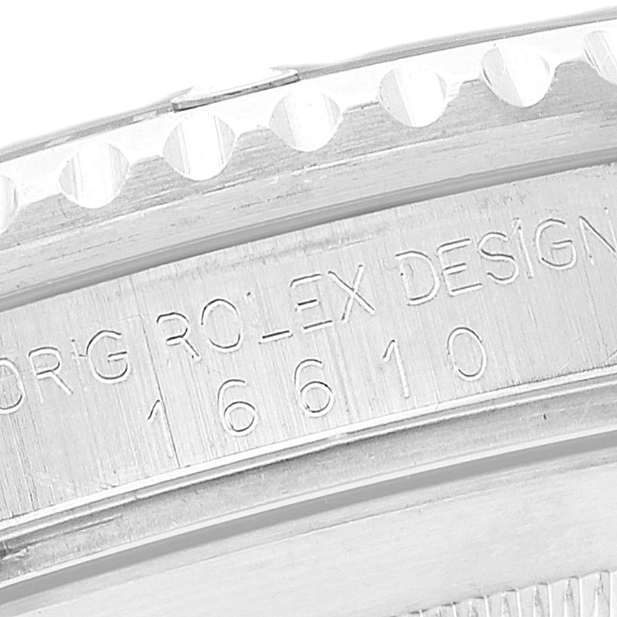 This image shows a close-up of the engraved model number and "Rolex Design" on the case side of a Rolex Submariner 16610 Men
s Stainless Steel Black Dial 16610 Men
s Stainless Steel Black Dial watch.