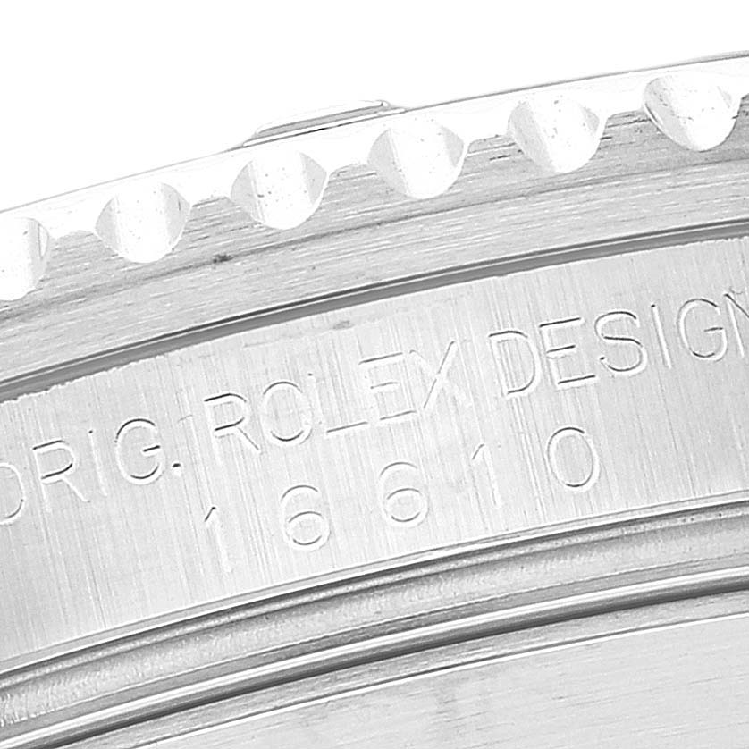 This image shows a close-up of the engraved case back and bezel edge of a Rolex Submariner 16610 Men
s Stainless Steel Black Dial 16610 Men
s Stainless Steel Black Dial watch.