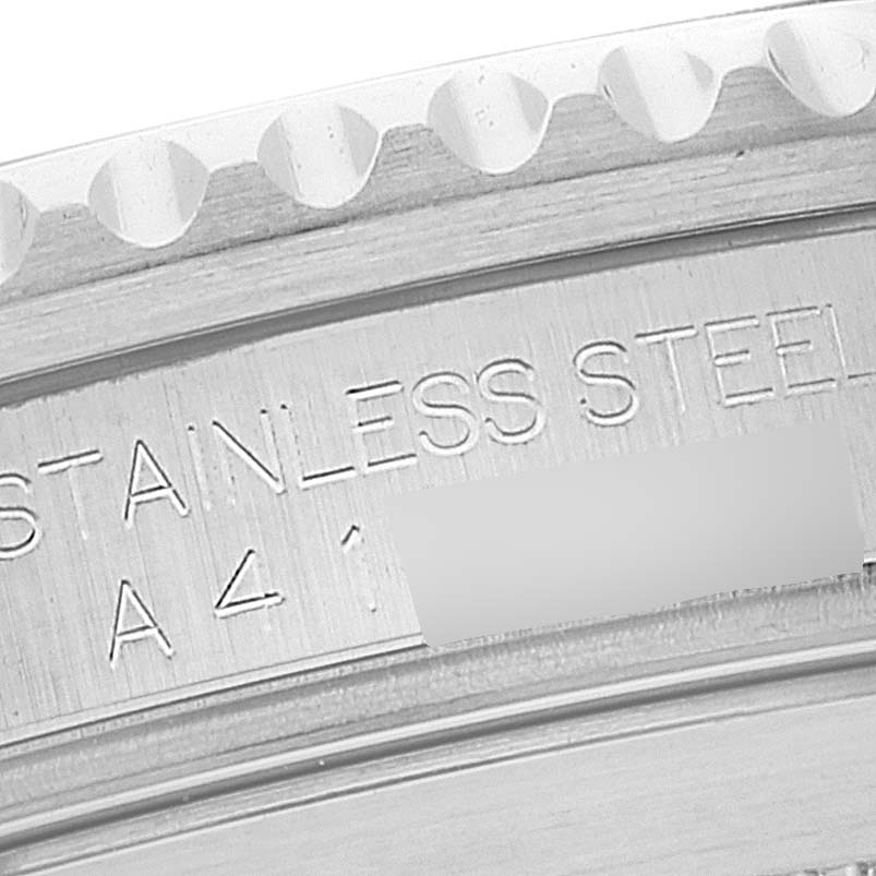 This close-up of the Rolex Submariner 16610 Men
s Stainless Steel Black Dial 16610 Men
s Stainless Steel Black Dial model shows the bezel
s edge and part of the engraved stainless-steel case back.