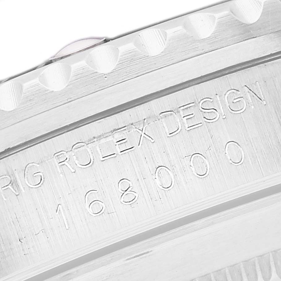 The image shows an angled close-up of the casing edge and engraved text of a Vintage Collection model by Rolex.