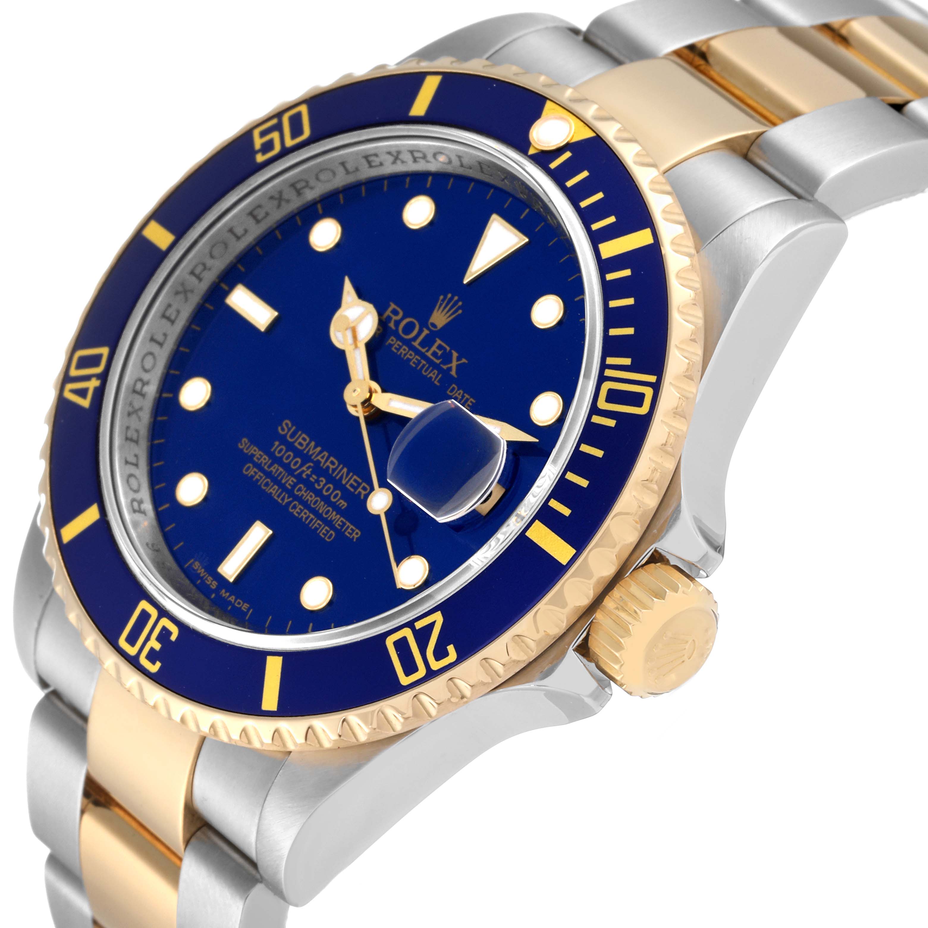 The image shows a side angle of a Rolex Submariner 16613 Men's Steel and Gold (two tone) Blue Dial 16613 Men's Steel and Gold (two tone) Blue Dial watch, highlighting its blue dial, bezel, and two-tone bracelet.