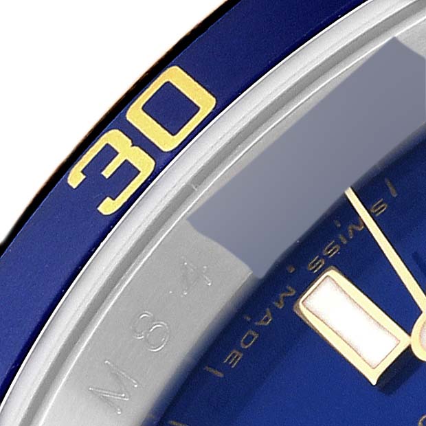 This image shows a close-up of the bezel and part of the dial of a Rolex Submariner 16613 Men's Steel and Gold (two tone) Blue Dial 16613 Men's Steel and Gold (two tone) Blue Dial watch, featuring the "30" marker.