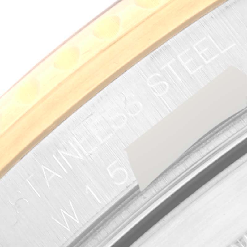 This close-up image of a Rolex Submariner 16613 Men's Steel and Gold (two tone) Blue Dial 16613 Men's Steel and Gold (two tone) Blue Dial watch shows the engraved "STAINLESS STEEL" and part of the case edge.