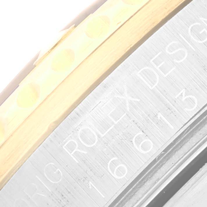 This image shows a close-up of the bezel and case edge of a Rolex Submariner 16613 Men's Steel and Gold (two tone) Blue Dial 16613 Men's Steel and Gold (two tone) Blue Dial watch, displaying the engraved model number.