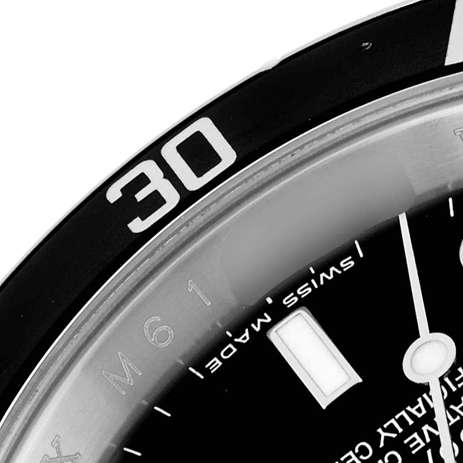 The image shows a partial close-up of the bezel
s 30-minute mark and the dial of a Rolex Submariner 16610 Men
s Stainless Steel Black Dial 16610 Men
s Stainless Steel Black Dial watch, including the "Swiss Made" text.