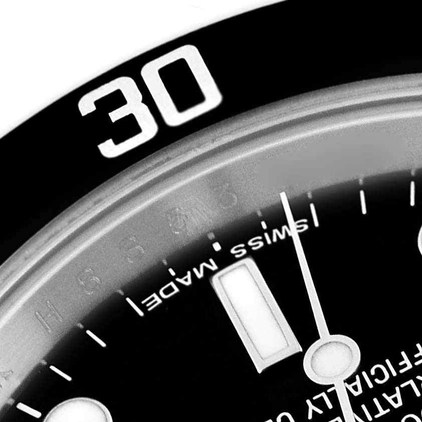 This close-up image of the Rolex Submariner 14060 Men
s Stainless Steel Black Dial 14060 Men
s Stainless Steel Black Dial watch displays part of the bezel marked "30" and a section of the dial.