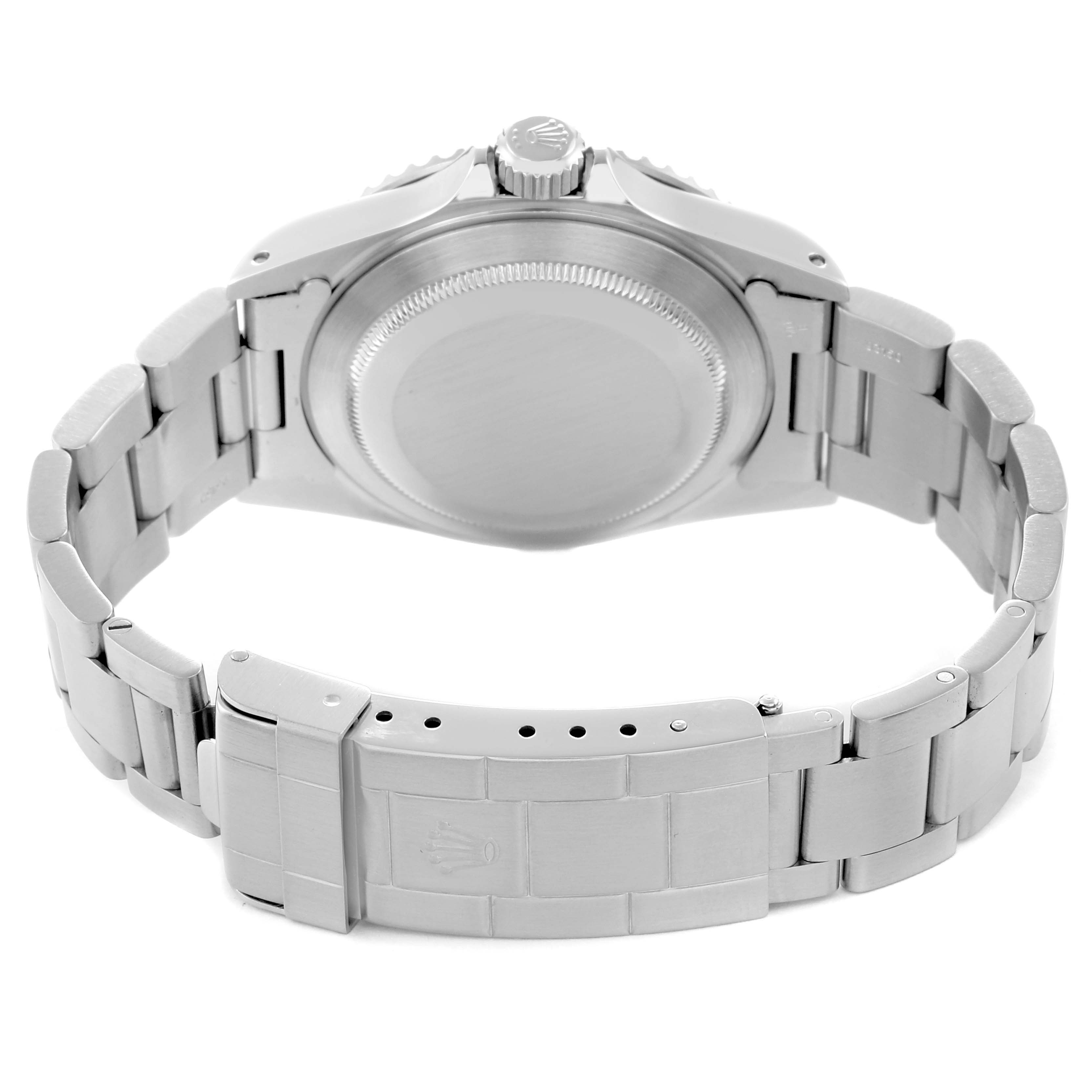 The image shows the Rolex Submariner model 14060M from the back, highlighting the clasp, bracelet, and case back.