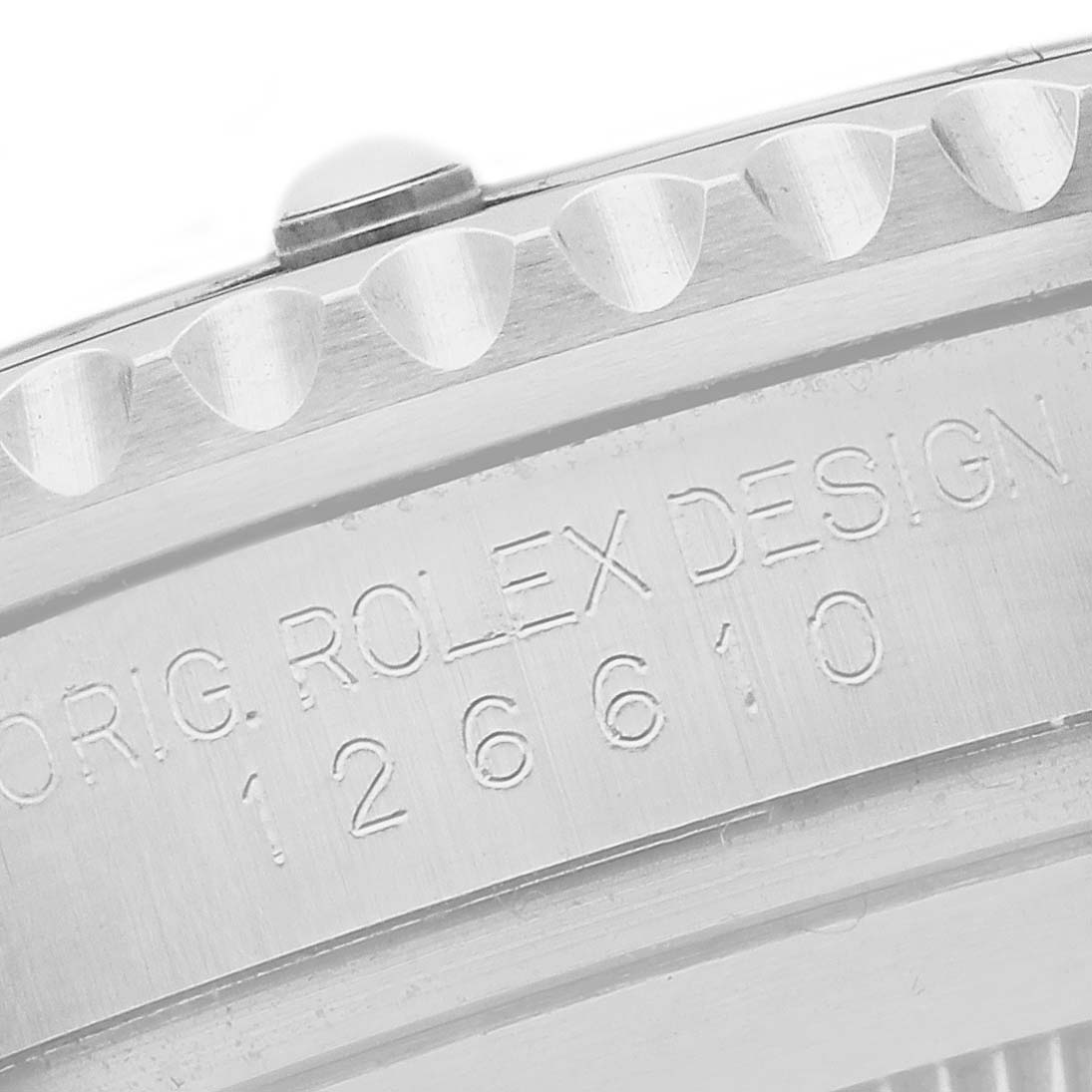 The image shows the side view of the Rolex Submariner 126610, focusing on the engraved model number and design details on the watch case.