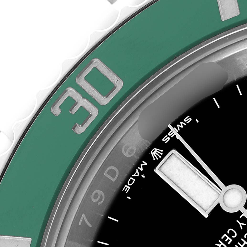The image shows a close-up of the Rolex Submariner model 126610
s green bezel and black dial, focusing on the "30" marker and part of the hands.