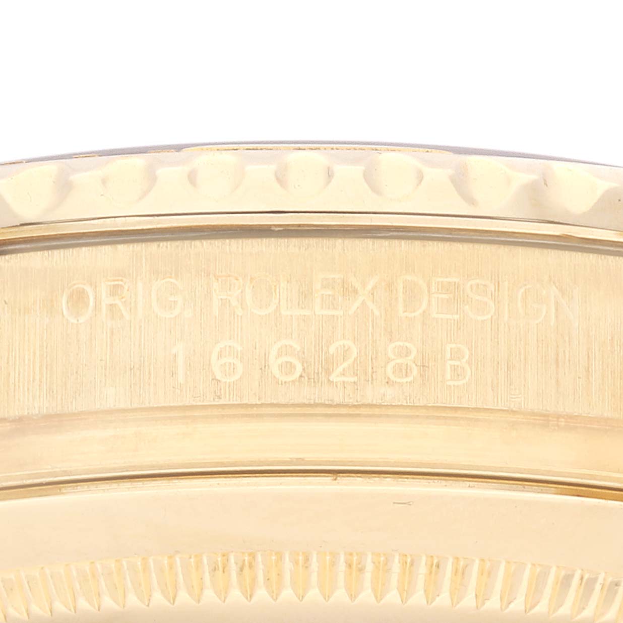 The image shows a close-up of the case side with engraved details of a Rolex Yacht-Master 16628 Men's Yellow Gold White Dial 16628 Men's Yellow Gold White Dial watch model 16628B.