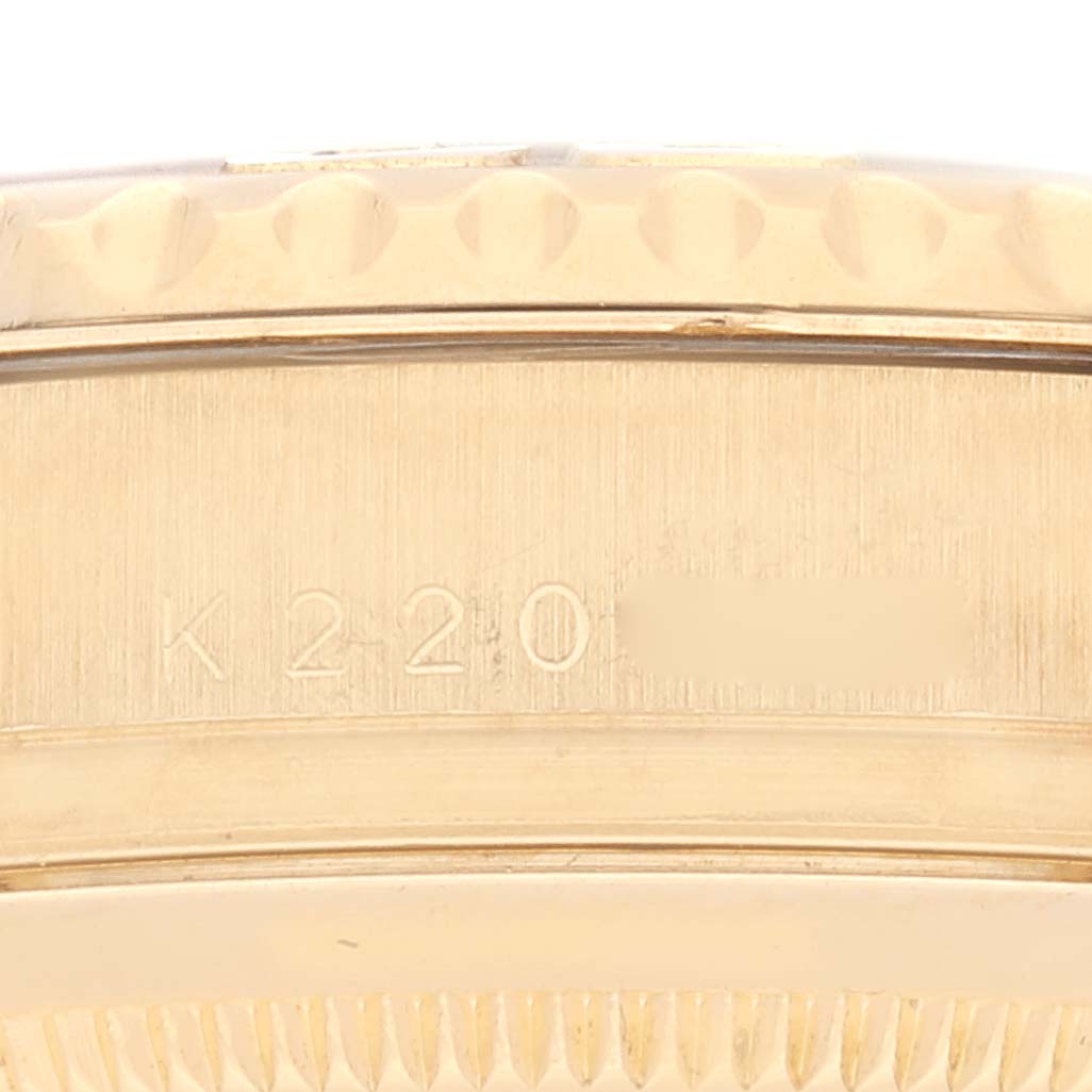 This image shows a close-up side view of the bezel and part of the case with the serial number of the Rolex Yacht-Master 16628 Men's Yellow Gold White Dial 16628 Men's Yellow Gold White Dial watch.