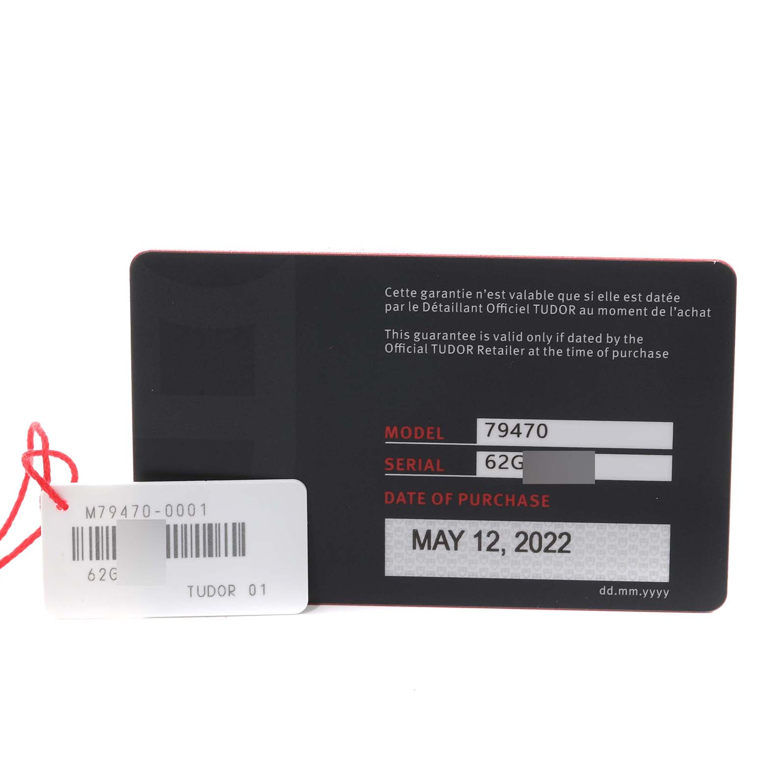 The image shows a Tudor Heritage Black Bay M79470-0003 Men's Stainless Steel Black Dial M79470-0003 Men's Stainless Steel Black Dial watch warranty card and hang tag, displaying the model, serial number, and purchase date.