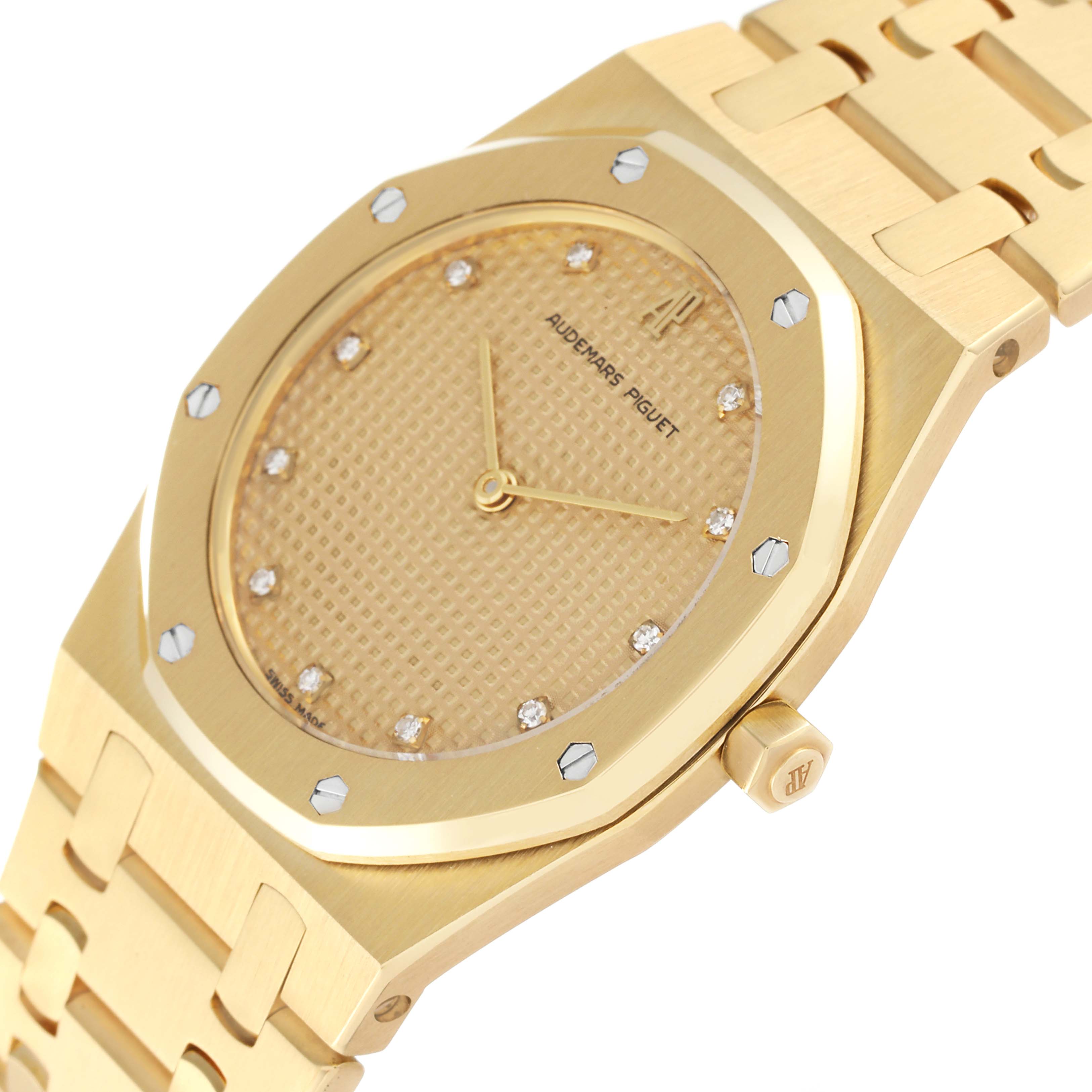 The image shows a close-up angle of an Audemars Piguet Royal Oak 56303BA Men's Yellow Gold Champagne Dial 56303BA Men's Yellow Gold Champagne Dial watch displaying the dial, crown, and part of the bracelet.