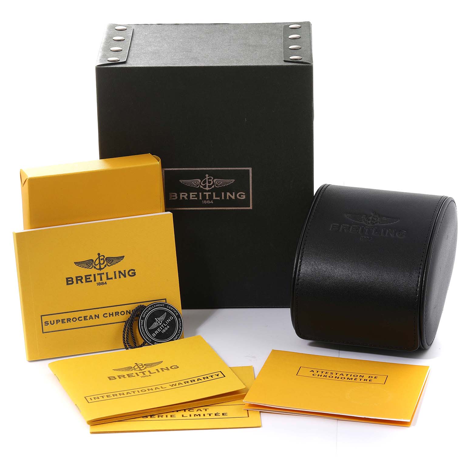 The image shows the packaging and accessories for a Breitling Superocean A13341 Men's Stainless Steel Black Dial A13341 Men's Stainless Steel Black Dial watch, including a box, a leather case, and various documents.