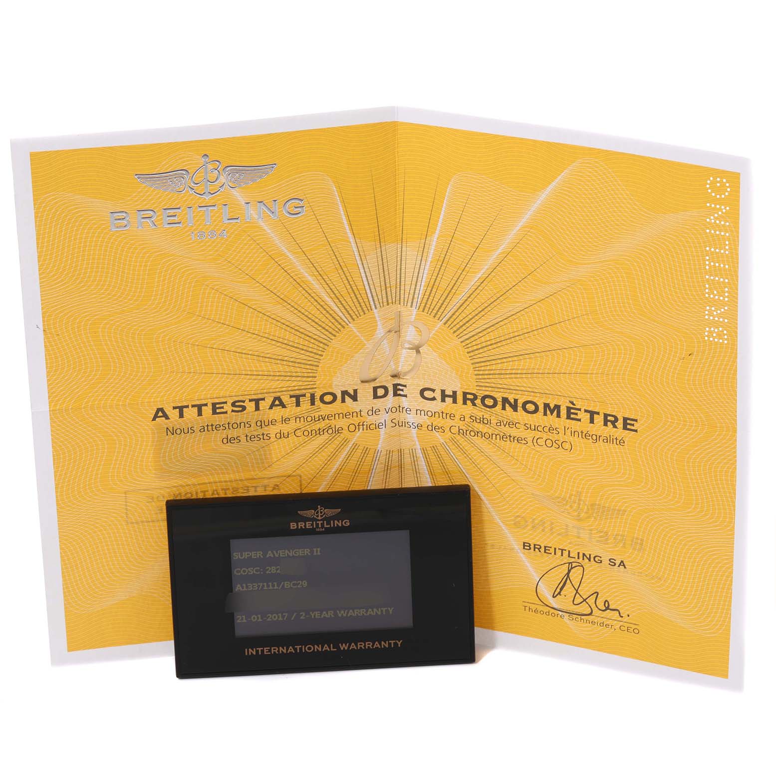 The image shows a yellow Breitling certificate and an international warranty card for the Avenger model by Breitling.