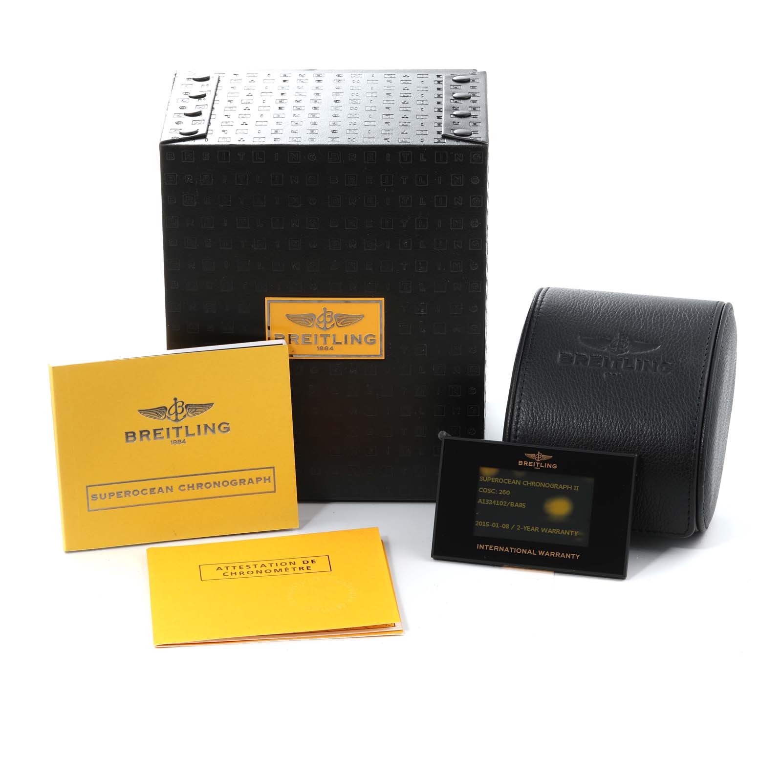 The image shows the Superocean model by Breitling packaging, instruction manuals, warranty card, and a watch case.