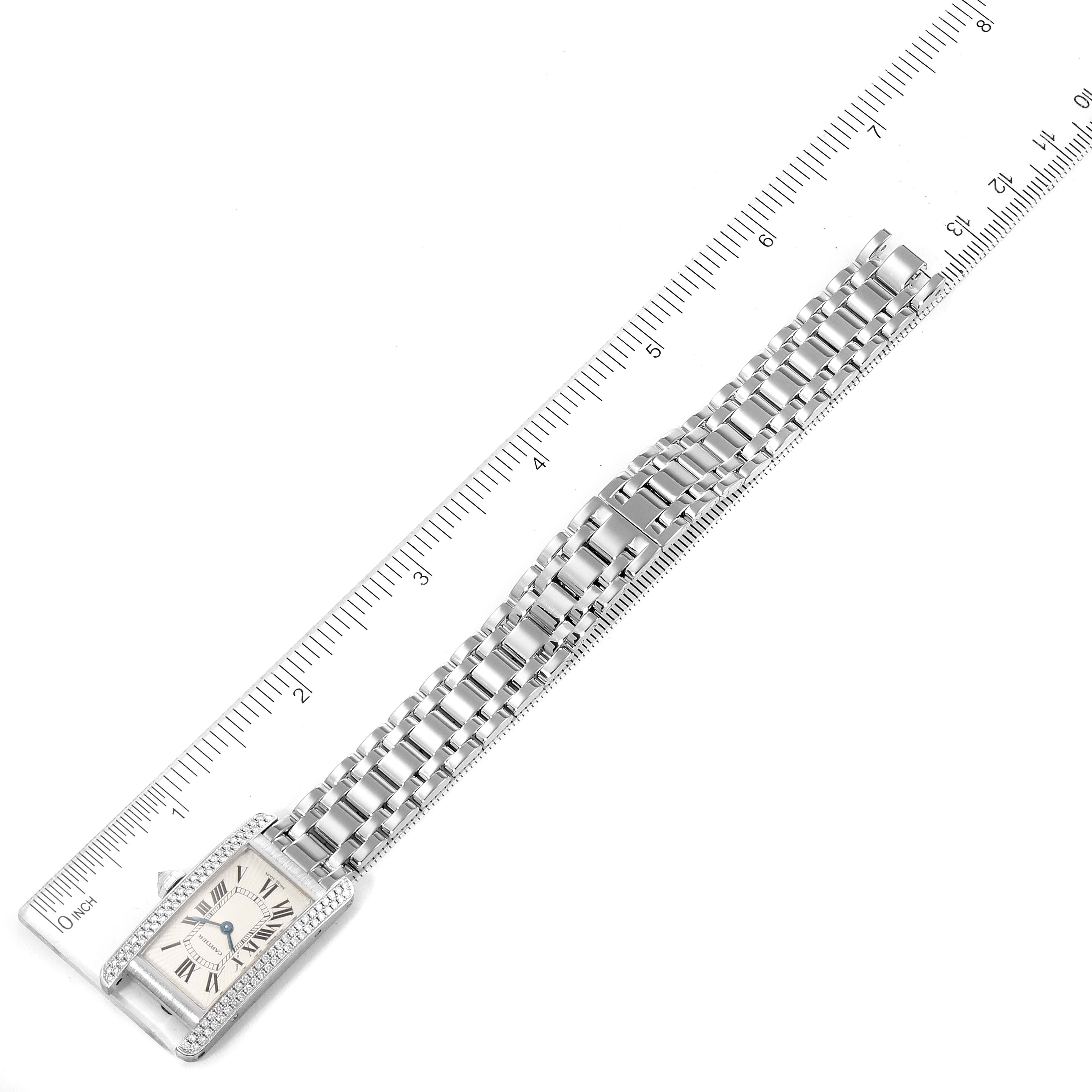 This image shows the Tank Americaine watch by Cartier from a top-down angle, placed next to a ruler for scale.