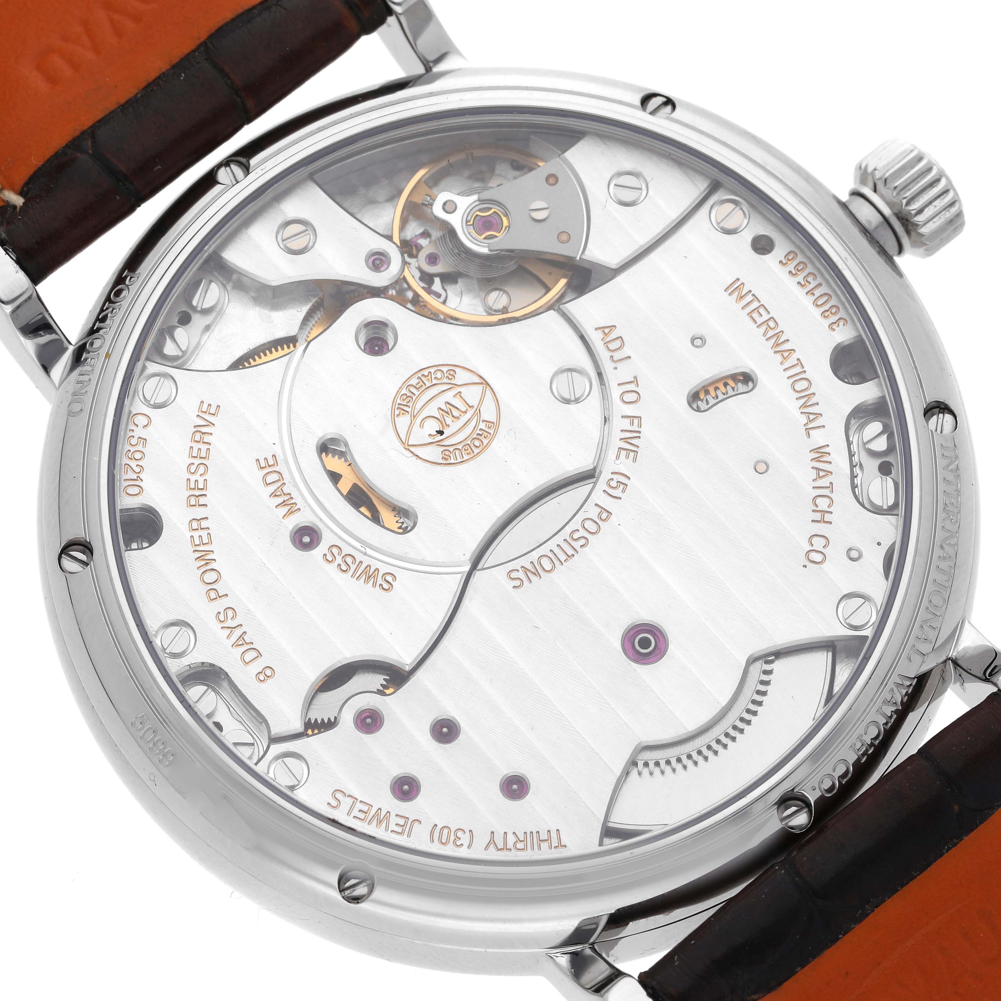 The image shows the back view of an IWC Portofino IW510103 Men's Stainless Steel Silver Dial IW510103 Men's Stainless Steel Silver Dial watch, highlighting its intricate mechanical movement and engravings.