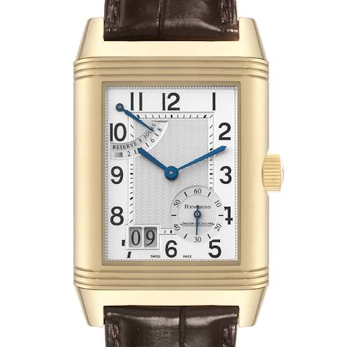 The image shows a front view of a Jaeger-LeCoultre Reverso watch with a rectangular gold case, white dial, blue hands, and brown leather strap.