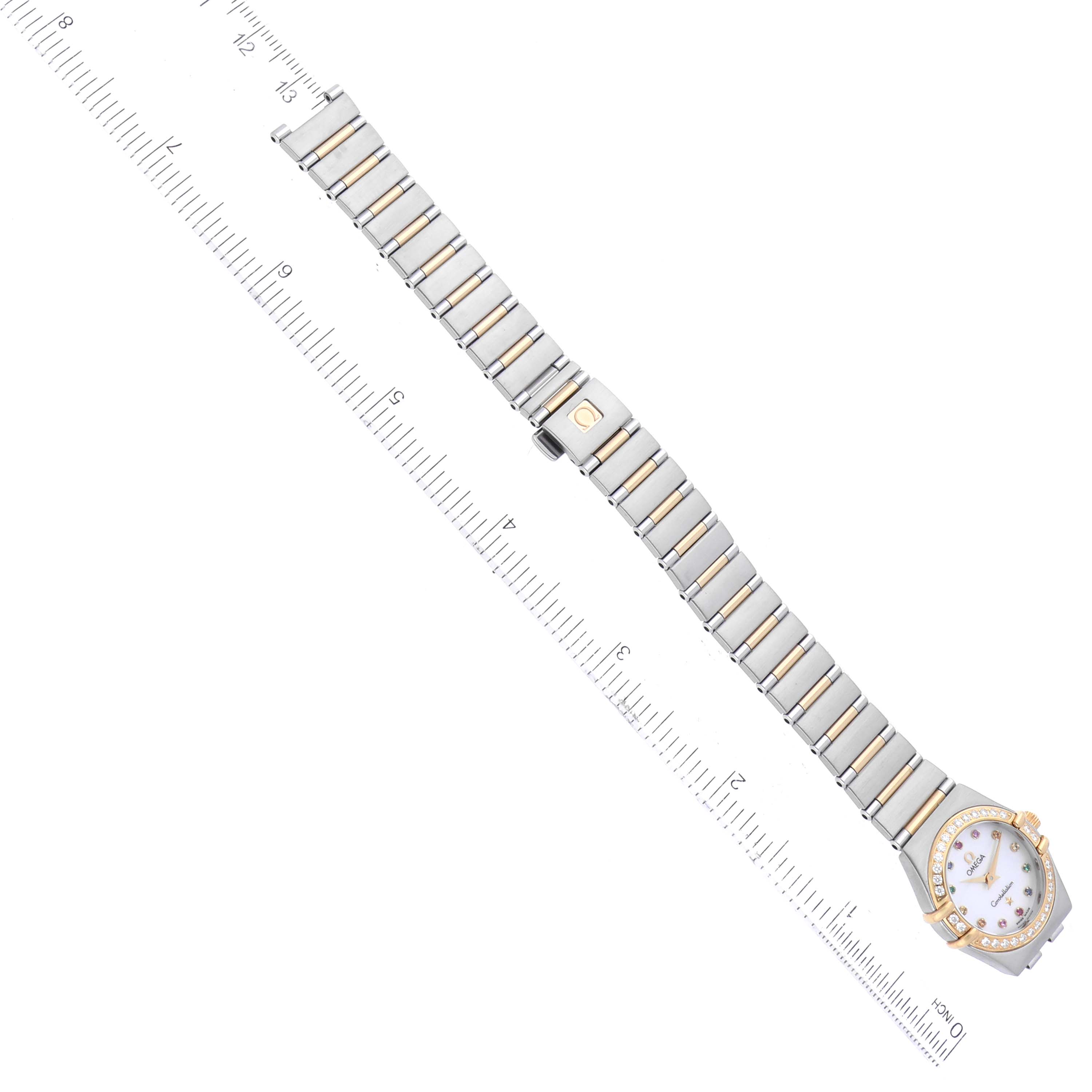 This image shows the Omega 1394.79.00 Women's Steel and Gold (two tone) Mother of Pearl Dial 1394.79.00 Women's Steel and Gold (two tone) Mother of Pearl Dial Constellation Steel Yellow Gold Diamond Mother of Pearl Iris Ladies Watch 1367.79.00 positioned next to a ruler.