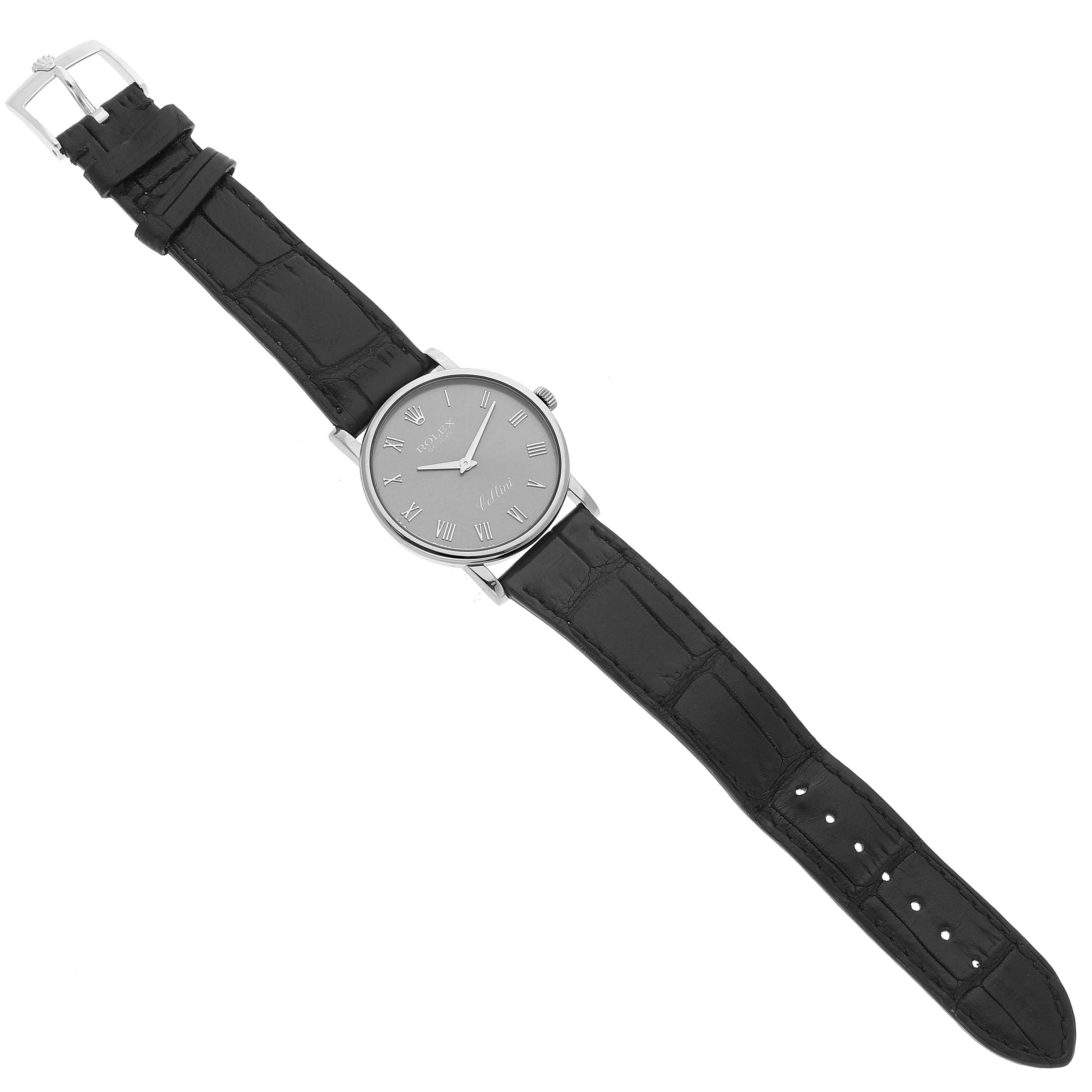 The image shows a Rolex Cellini 5115 Men's White Gold Grey Dial 5115 Men's White Gold Grey Dial watch from a top-down angle, displaying its black leather strap and gray dial with Roman numerals.