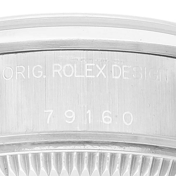 This image shows a close-up of the side engraving on a Rolex Date 79160 Women's Stainless Steel Black Dial 79160 Women's Stainless Steel Black Dial model watch, displaying "ORIG. ROLEX DESIGN" and the model number 79160.