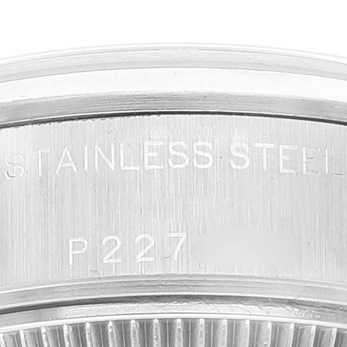 Close-up of the stainless steel case back of a Rolex Date 79160 Women's Stainless Steel Black Dial 79160 Women's Stainless Steel Black Dial model, showing engraved text and part of the bezel.