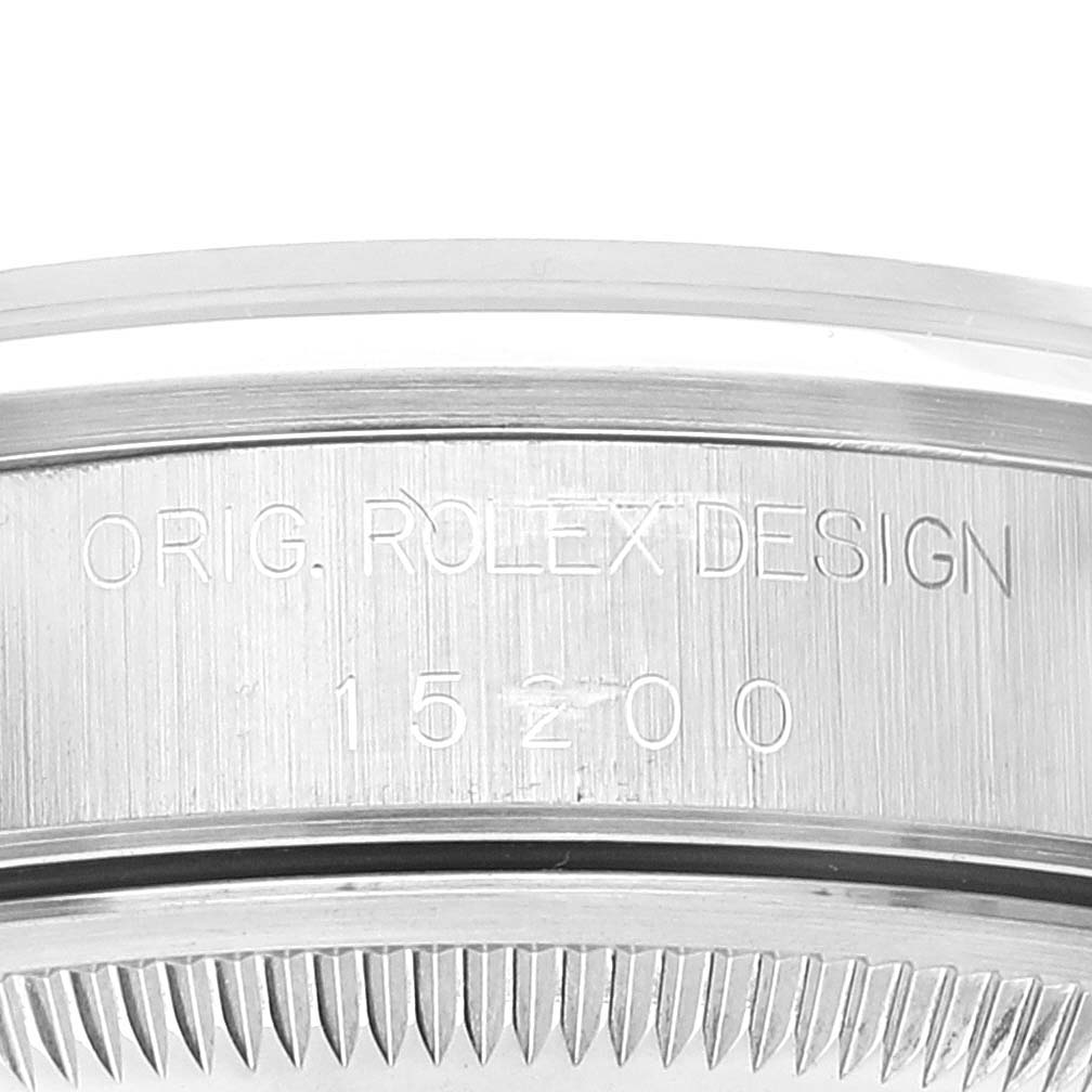 The image shows a close-up of the side of a Rolex Date 15200 Men
s Stainless Steel Pink Dial 15200 Men
s Stainless Steel Pink Dial model watch case, engraved with "ORIG. ROLEX DESIGN 15200."