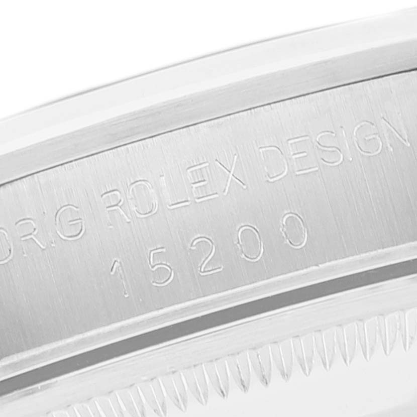The image shows an engraving on the side of the case back of a Rolex Date 15200 Men's Stainless Steel Grey Dial 15200 Men's Stainless Steel Grey Dial model 15200.