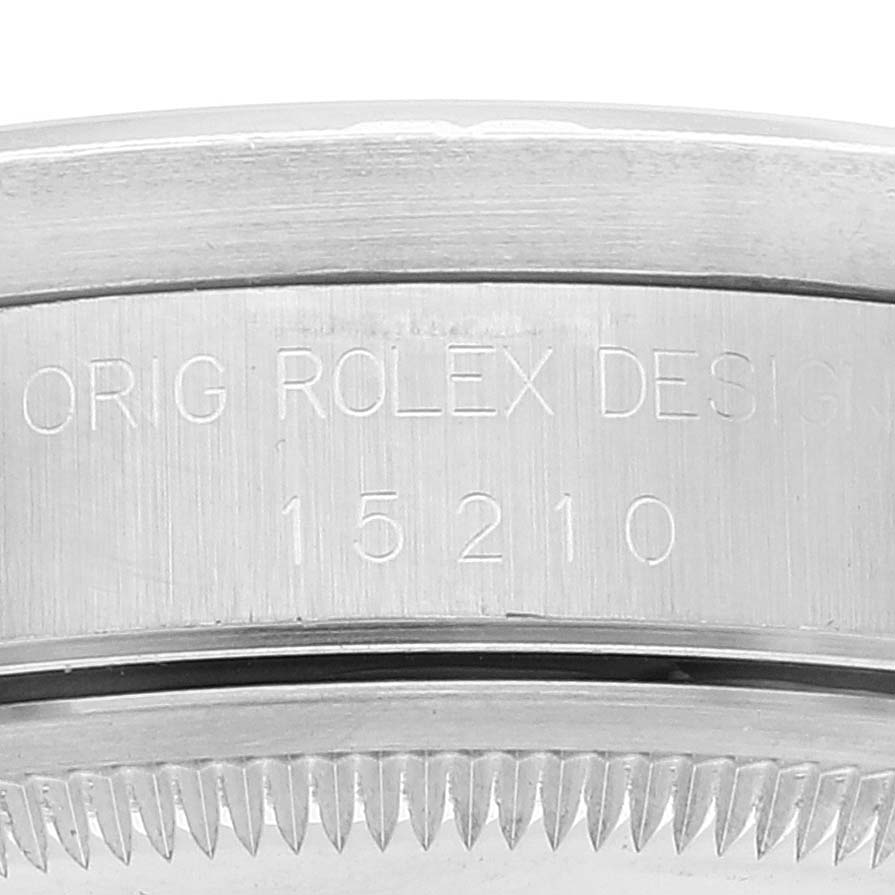 This image shows a close-up of the side of a Rolex Date 15210 Men
s Stainless Steel White Dial 15210 Men
s Stainless Steel White Dial model watch, focusing on the engraved design number 15210.