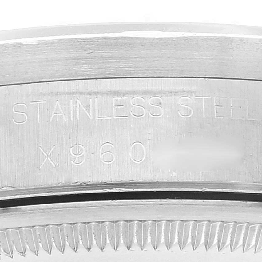 This image shows a close-up of the engraved serial number and "STAINLESS STEEL" text on the casing of a Rolex Date 15210 Men
s Stainless Steel White Dial 15210 Men
s Stainless Steel White Dial model watch.