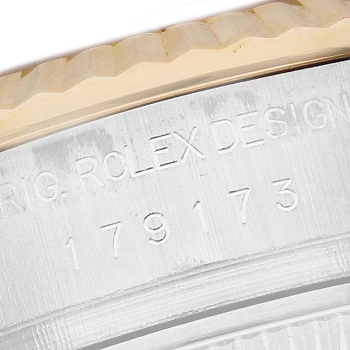 This close-up image shows the engraved serial and model number on the side of the Rolex Datejust 179173 Women's Steel and Gold (two tone) Silver Dial 179173 Women's Steel and Gold (two tone) Silver Dial watch.