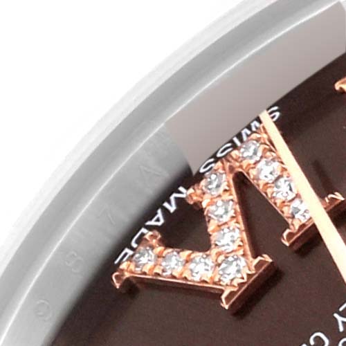 Close-up of a Rolex Mid-Size 178341 Women's Steel and Gold (two tone) Brown Dial 178341 Women's Steel and Gold (two tone) Brown Dial watch showing part of the bezel and part of a diamond-set Roman numeral.