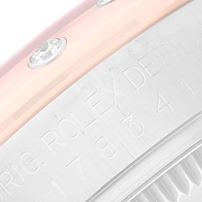 The image shows a close-up of the Rolex Mid-Size 178341 Women's Steel and Gold (two tone) Brown Dial 178341 Women's Steel and Gold (two tone) Brown Dial model, highlighting the bezel with diamonds and part of the engraved casing.