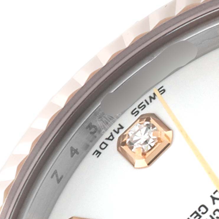 Close-up of a Rolex Mid-Size 178271 Women's Steel and Gold (two tone) White Dial 178271 Women's Steel and Gold (two tone) White Dial watch showing the bezel, part of the dial, and diamond hour marker at an angle.
