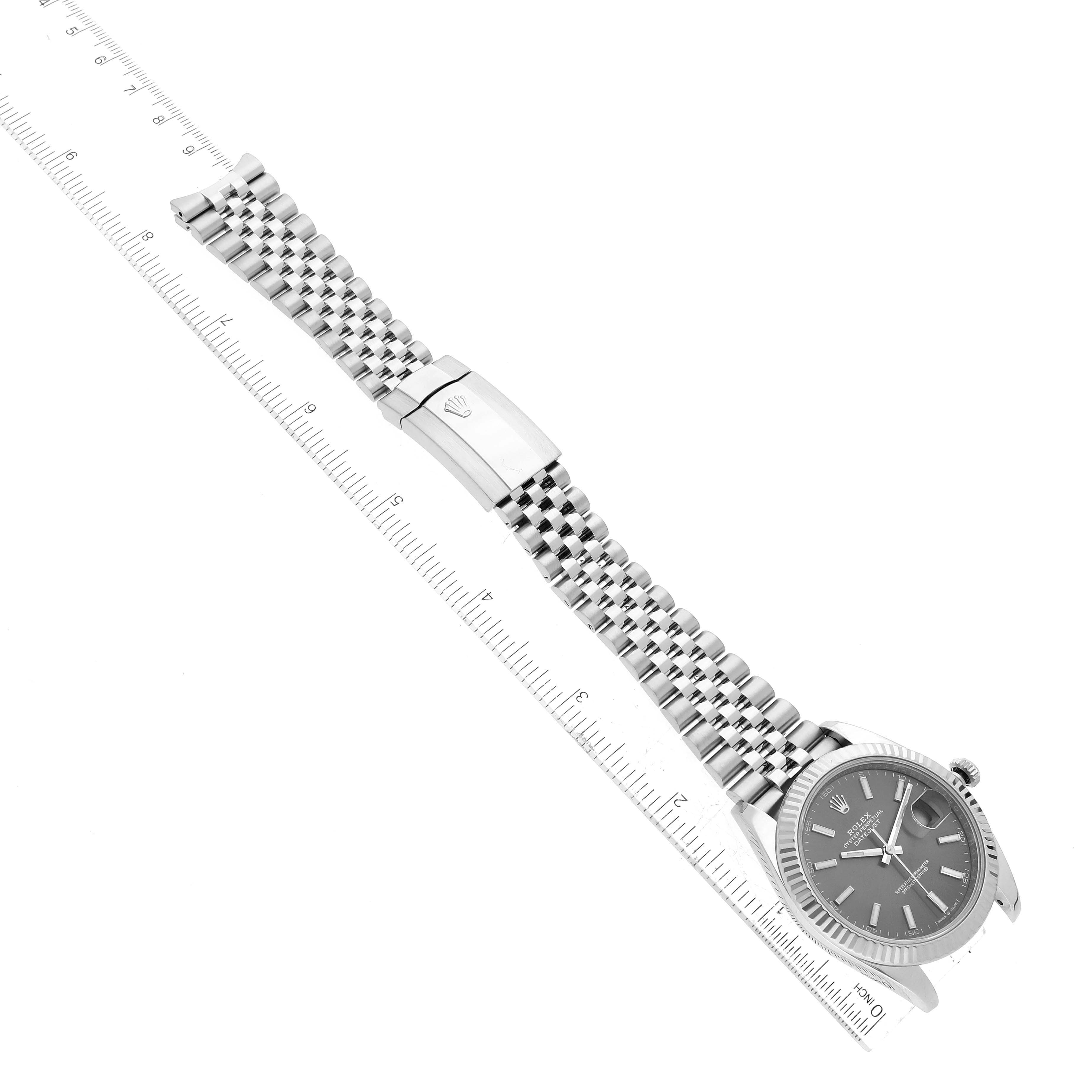 The image shows a Rolex Datejust 41 126334 Men's Stainless Steel Grey Dial 126334 Men's Stainless Steel Grey Dial watch and band laid flat on a ruler, highlighting the watch face, bracelet, and clasp.