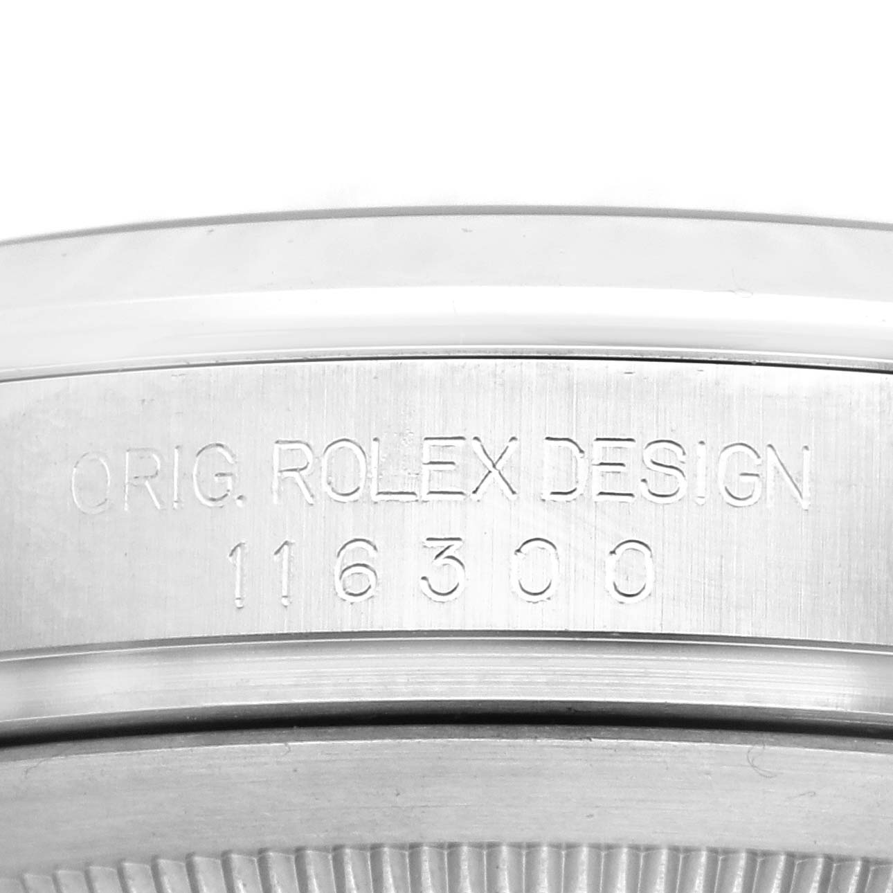 This image shows a close-up of the Rolex Datejust 41 116300 Men's Stainless Steel Black Dial 116300 Men's Stainless Steel Black Dial model's case with the "ORIG. ROLEX DESIGN" and model number engraved.