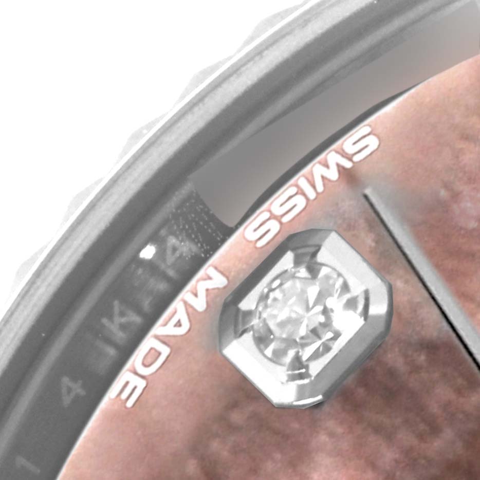 Close-up view of the Rolex Mid-Size 178274 Women's Stainless Steel Mother of Pearl Dial 178274 Women's Stainless Steel Mother of Pearl Dial model watch, showing part of the dial, bezel, and a diamond marker.