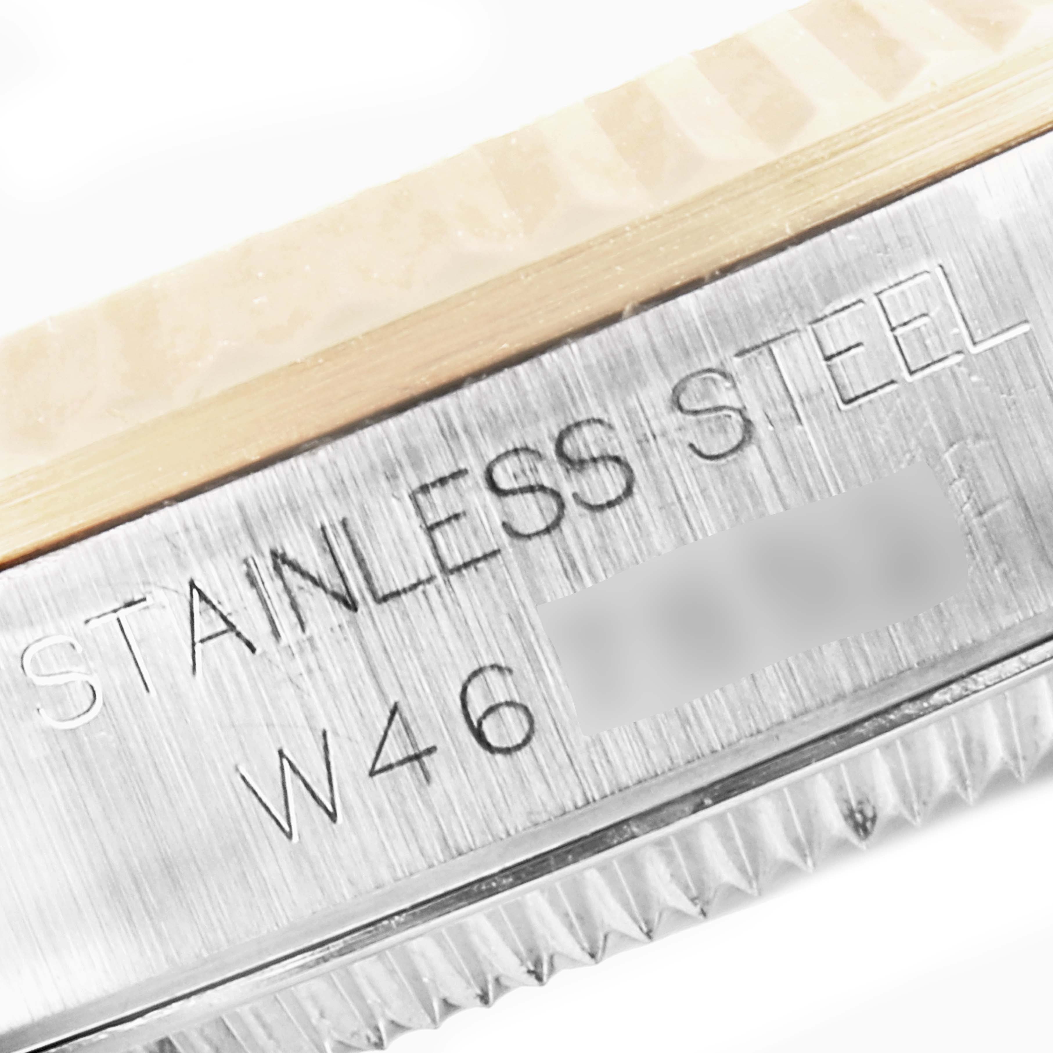 The image shows a close-up of the stainless steel casing edge of a mid-size Rolex watch.